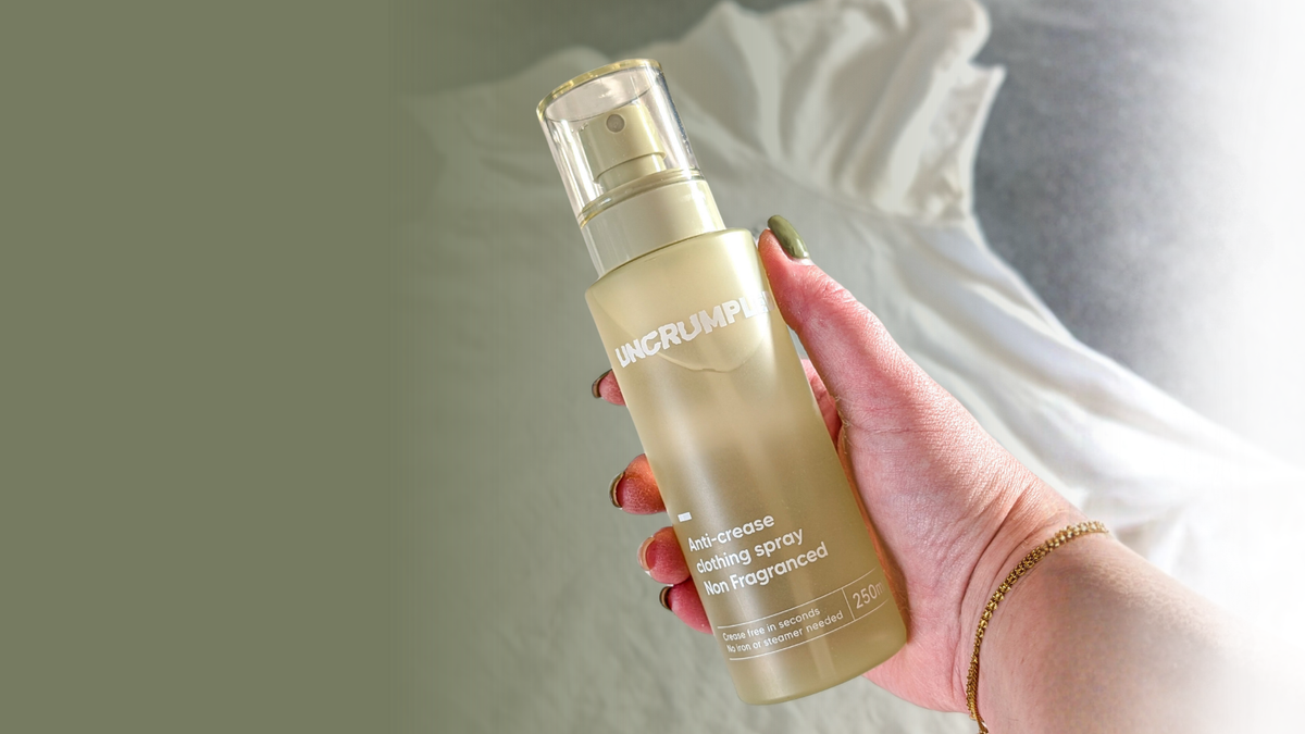 Hand holding a regular-sized 250ml Uncrumpled anti-crease spray bottle 